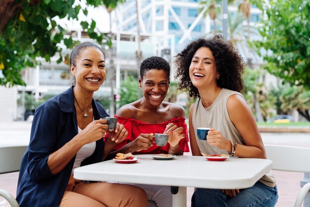 Three mixed race hispanic and black women bonding outdoors