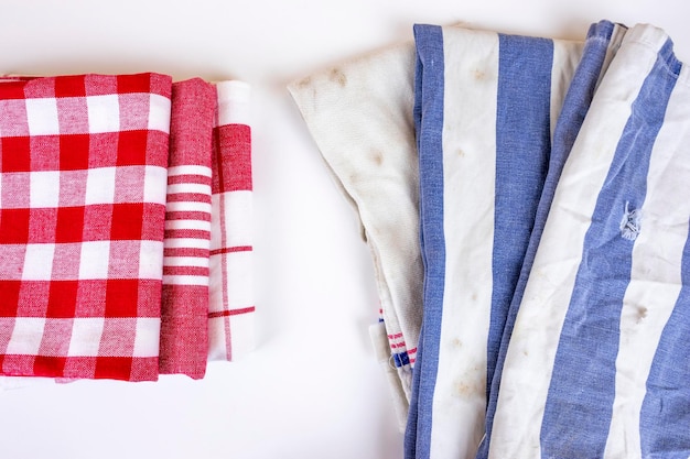 Premium Photo  Three new red checkered kitchen picnic towels folded versus  old dirty torn blue cloth towels cleanin