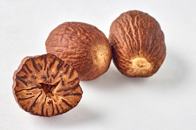 Three nutmegs on a white background