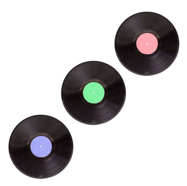 three old vinyl records in different colors on white background