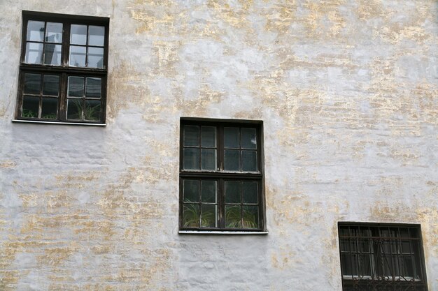 Three old windows in house wall