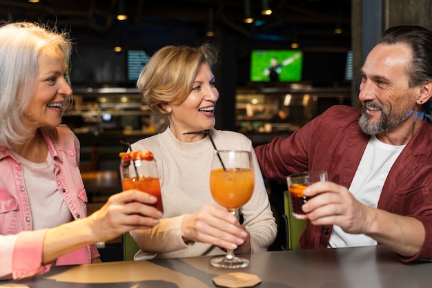 レストランで酒を飲んでいる3人の年配の友達