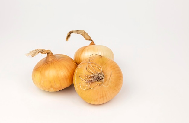 Three onions on a white background Onions are onion