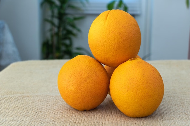 Three oranges on a table in the kitchen closeup