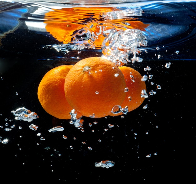 Three oranges in water