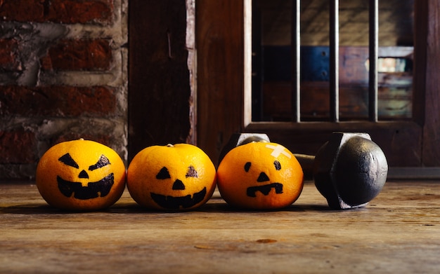 Three Oranges with Halloween Pumpkins face