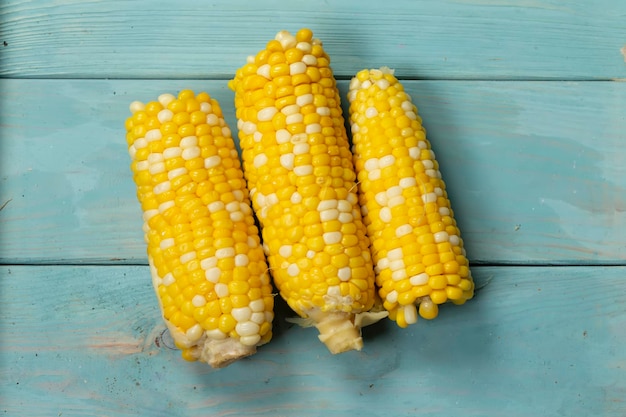 Three packs of corn on a wooden background