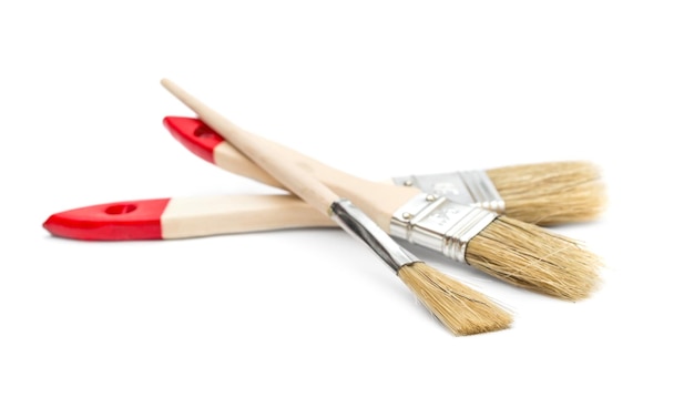 Three paint brushes on white background