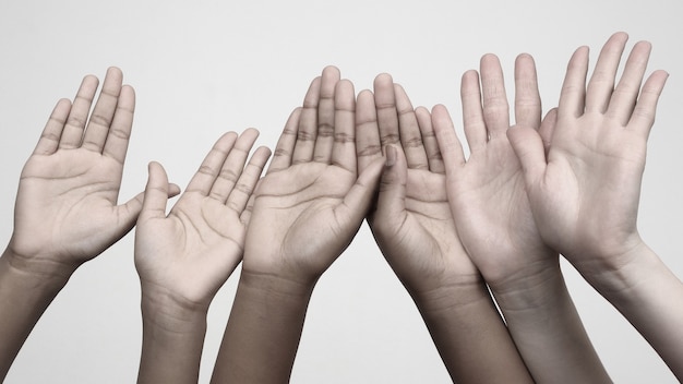 Photo three pairs of hands raised up