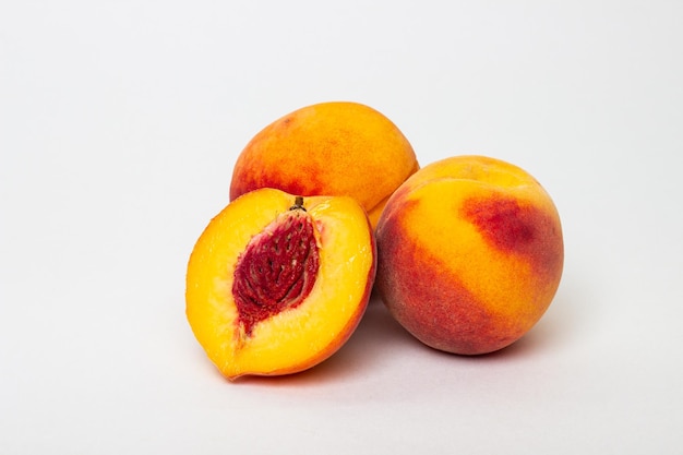 three peaches on a white background