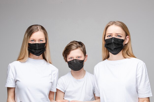 Three people in black anti-bacterial masks.