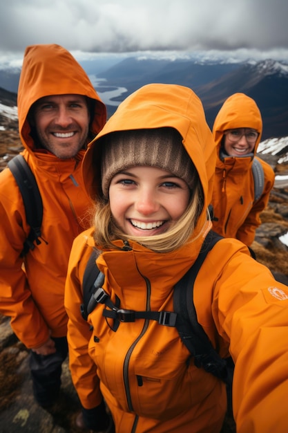 Three people in orange on the top of mountain jackets taking a selfie ai