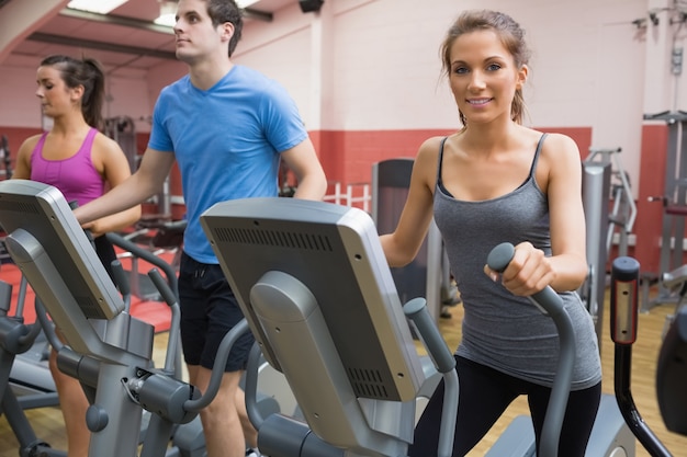 Three people stepping on step machine