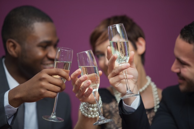 Three people toasting and celebrating in a casino