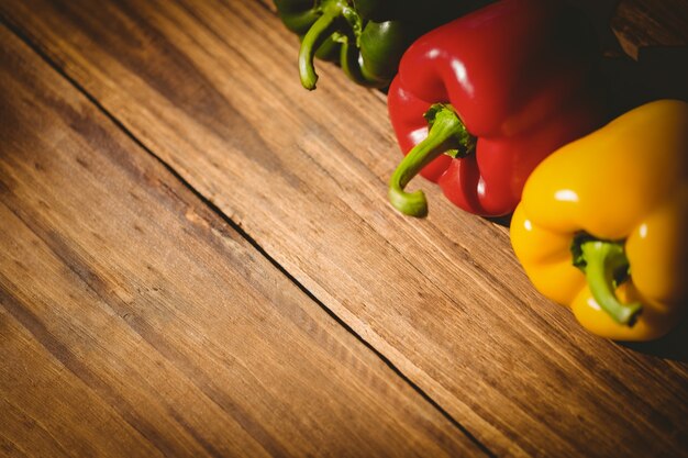 Three peppers on chopping board