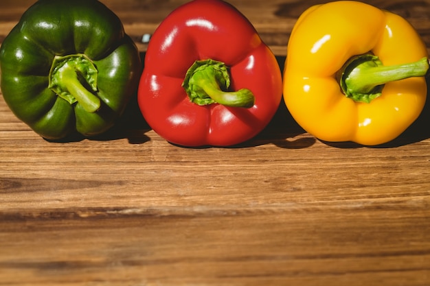 Three peppers on chopping board