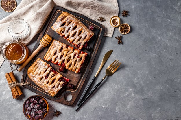 Three pieces of sweet cake with berry jam