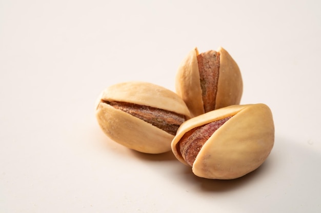 Three pistachio on a white isolated background