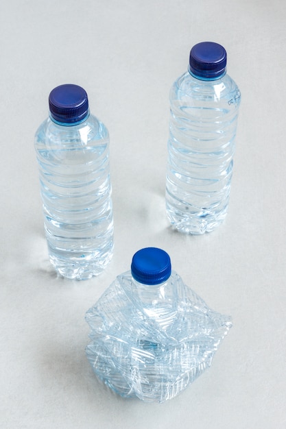 Three plastic bottles of mineral water