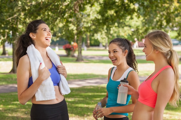 Three pretty sporty friends chatting 