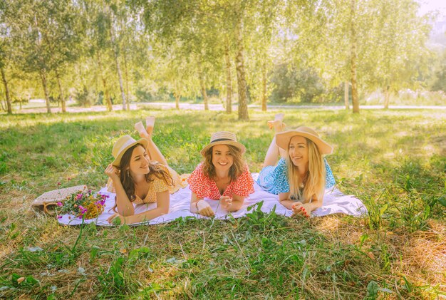 Three pretty women at a picnic in nature