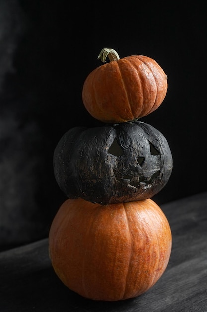 Three pumpkins on a black background