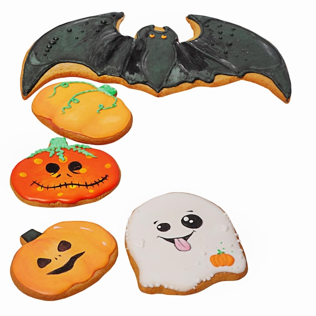 Three pumpkins a ghost and a bat are gingerbread cookies for Halloween Happy Halloween