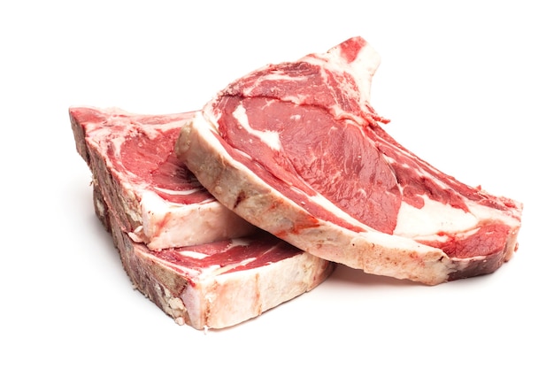 Three raw veal steaks isolated on a white background