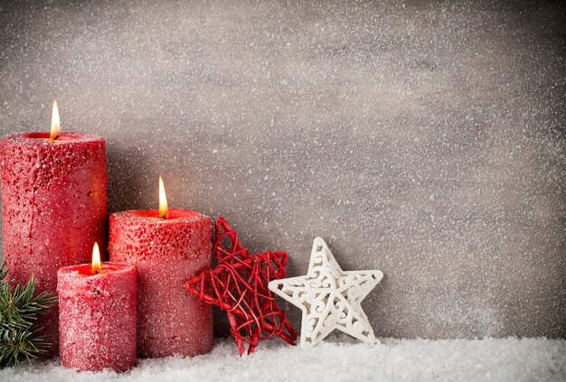 Three red candles on gray surface, Christmas decoration. Advent mood.