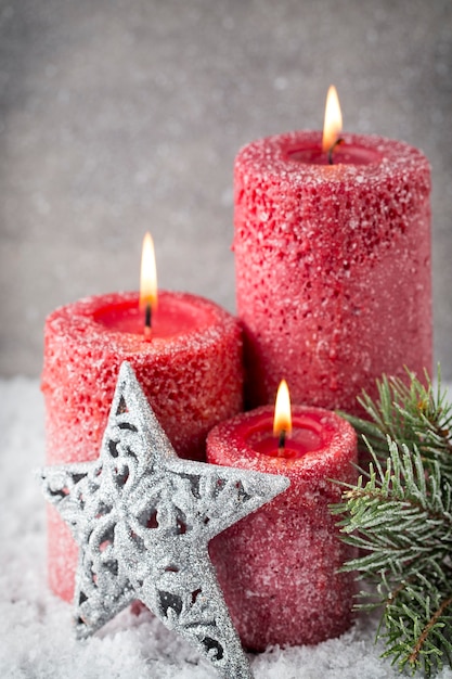 Three red candles on gray surface, Christmas decoration. Advent mood.