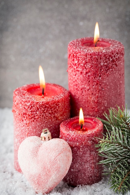 Three red candles on gray