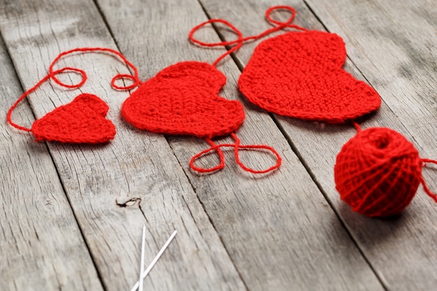 Three red knitted hearts, symbolizing love and family. Family relationship, bonds.