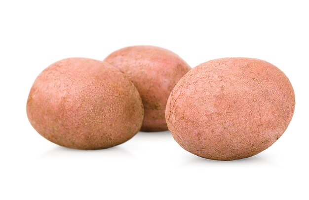 Three red potatoes on an isolated white background