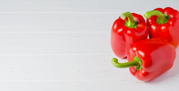 Three red ripe bell peppers