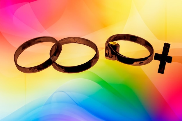 Three rings on a rainbow background trial marriage concept is the marriage formed by three people