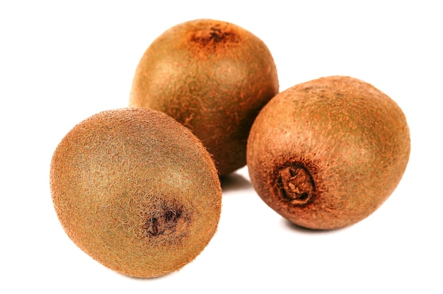 Three ripe kiwi on white background