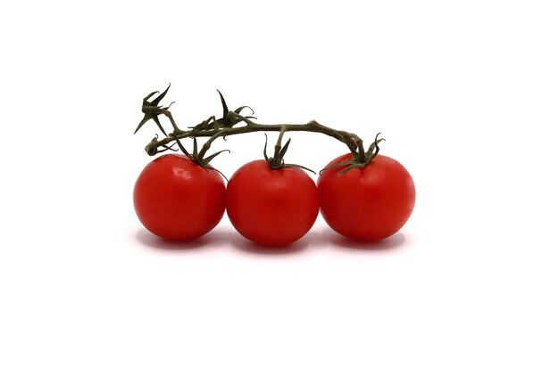 Three ripe red tomatoes on a light background. Natural product. Natural color. Close-up.