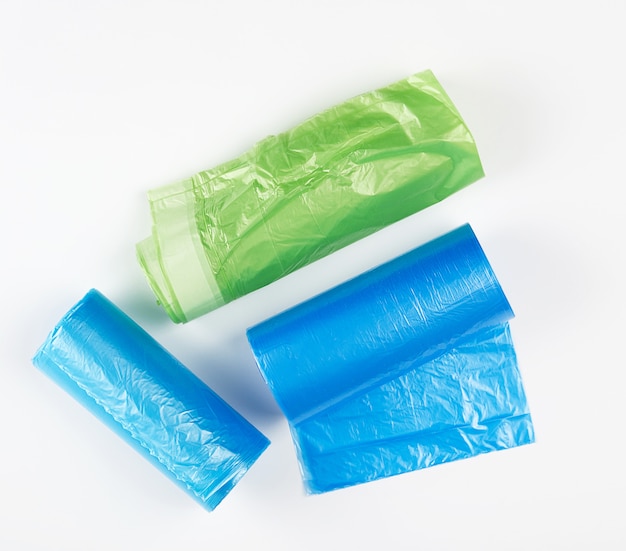 Three rolled up rolls with plastic garbage bags 