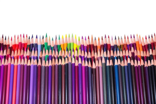 Three rows of colored pencils for painting on a white background