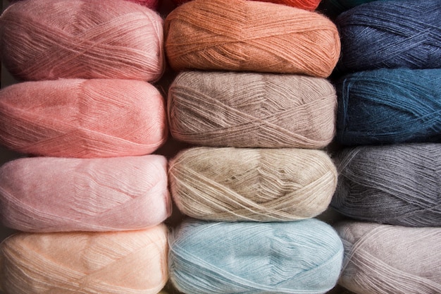 Three rows of multicolored yarn threads Threads in dark and light colors as a background