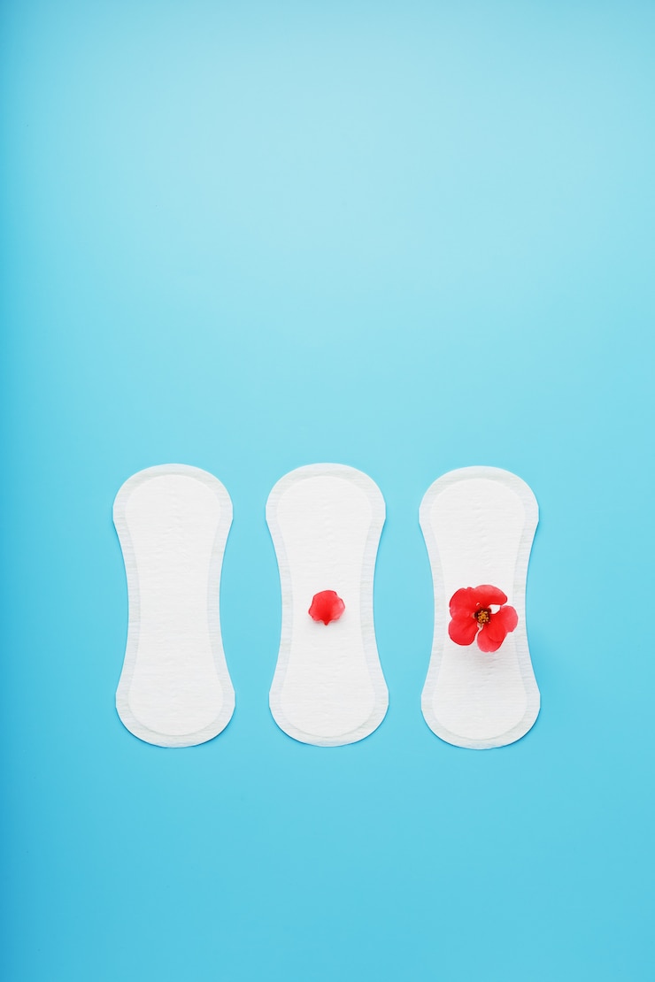 Photo three sanitary pads on blue. the concept of critical days, menstrual cycles in several stages.
