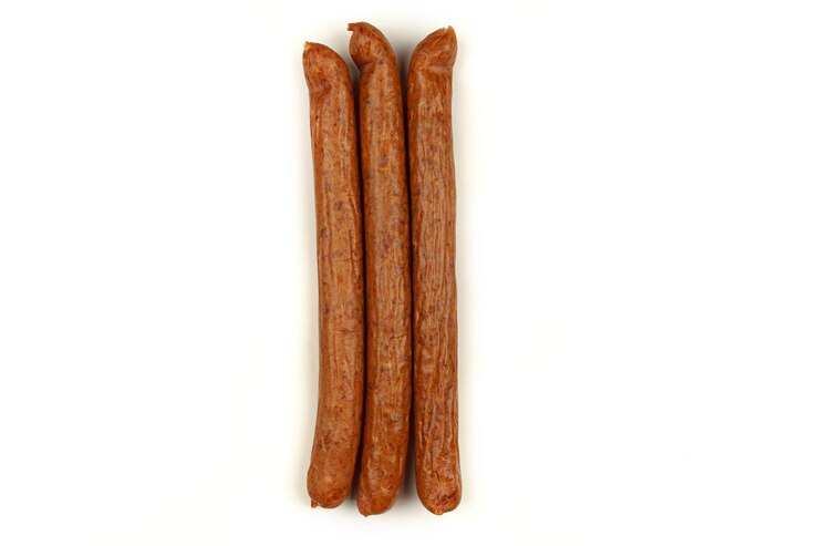 Three sausages lie on a white background Isolated