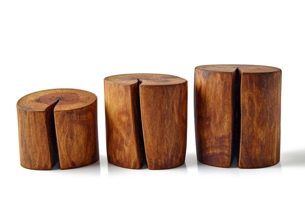 Photo three sawn brown tree trunks with knots and cracks isolated on a white background podium for demonstrating the advertised product