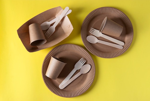 three sets disposable biodegradable tableware of craft paper and wood cutlery