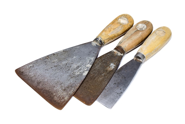 Three shabby putty knife on white background