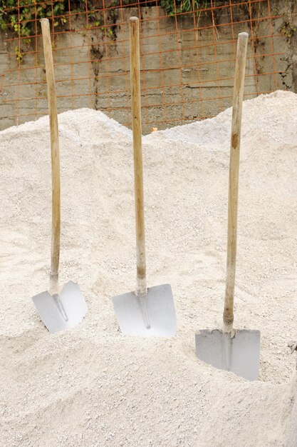 Три лопаты, подготовленные для работы на песке (пешеходном)