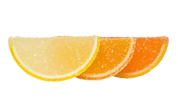 Three slices of yellow and orange marmalade sprinkled with sugar stand one behind another