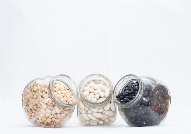 Three small bowl full of various beans