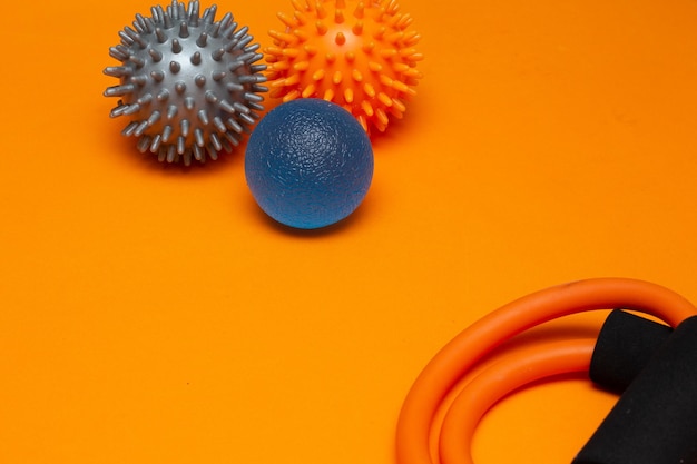 Three small pilates balls on the orange background