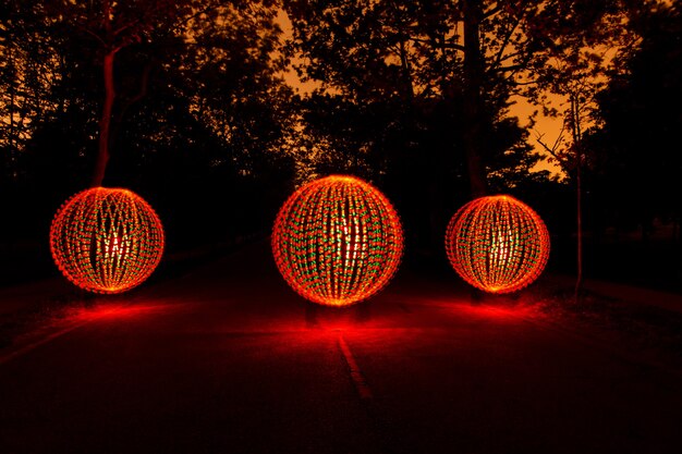 Three spheres of light in the middle of an abandoned road